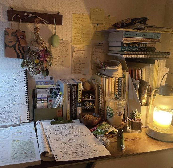 the desk is cluttered with books, papers and other things to do on it