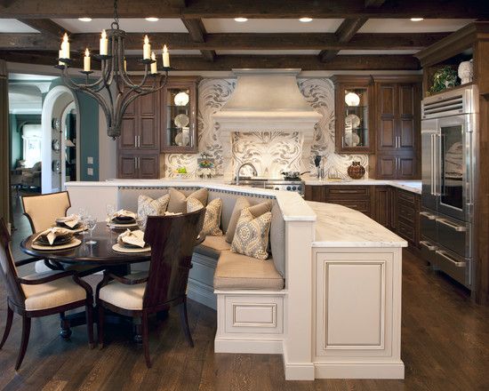 a large kitchen with an island and dining table