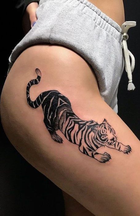 a tiger tattoo on the thigh