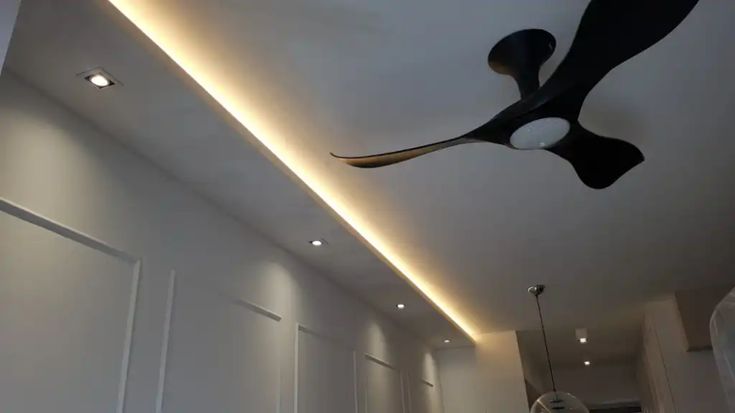 a ceiling fan is hanging from the ceiling in a room with white walls and flooring