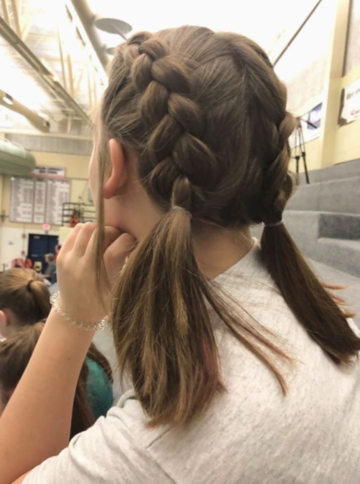 a girl with long hair braided into a pony tail