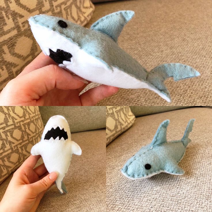 someone is holding two stuffed shark toys in their left hand and the other one has it's mouth open