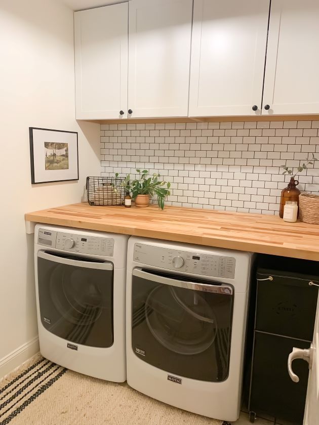 a washer and dryer sitting in a kitchen next to each other on top of a counter