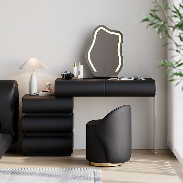 a living room with black furniture and a mirror on the wall