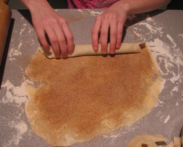 a person rolling out dough on top of a table