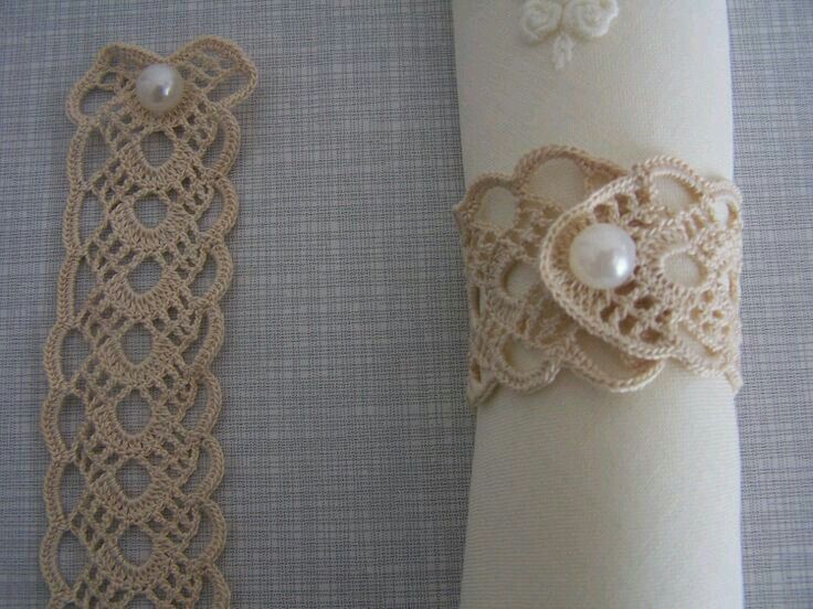 two pieces of crochet lace with pearls on them are next to each other