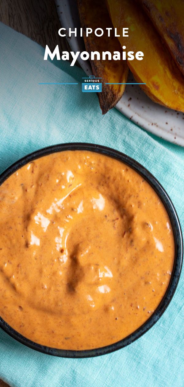 chipotle mayonnaise in a black bowl on top of a blue napkin