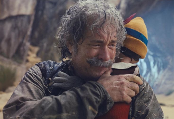 a man and woman hugging each other in the desert