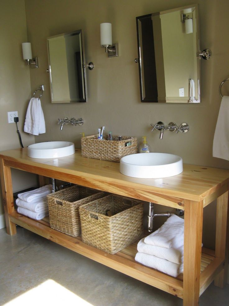 a bathroom with two sinks and mirrors on the wall