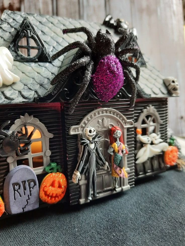 a house decorated for halloween with decorations on the roof