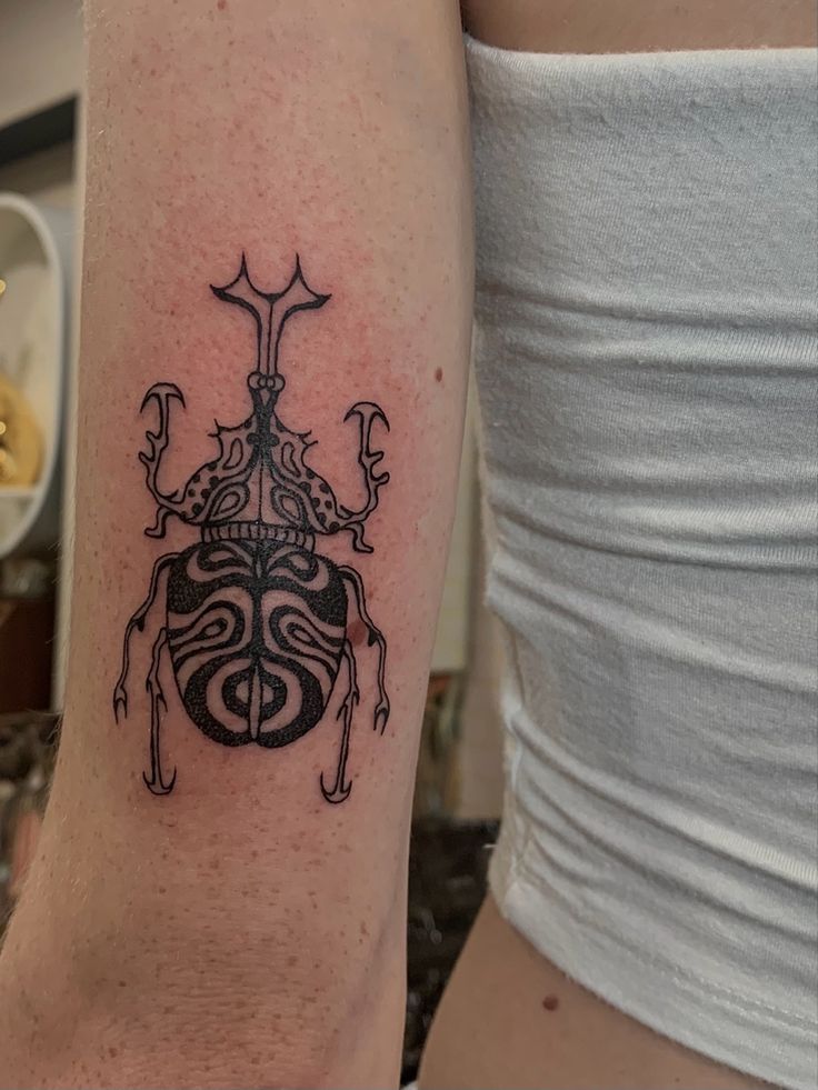 a lady bug tattoo on the right arm