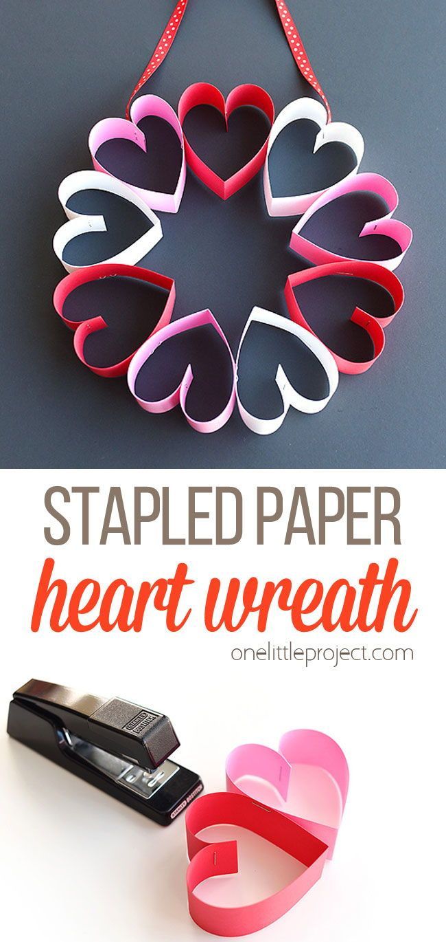 heart shaped paper hanging on a wall with text overlay that reads, staplested paper heart wreath