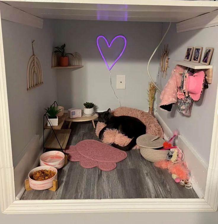 a cat is sleeping in the corner of a room filled with toys and other items