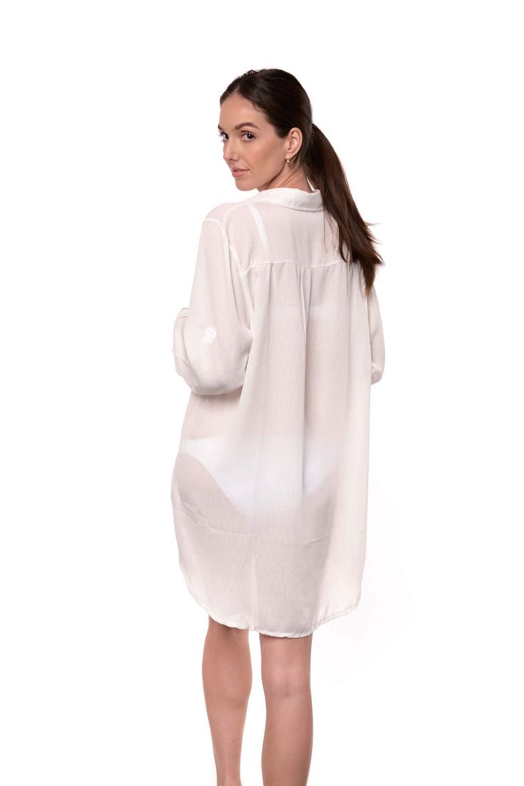 The Lydia is a button-up cover-up that can double as a shirt for a casual look. The off-white fabric has a light texture, and it is breathable and comfortable. The long sleeves can be folded and secured with a button on the side. One size. one size shoulder to bottom length: 35" (89cm) sleeves length: 21" (54cm) 100% Rayon (Viscose) Relaxed Fit Long Sleeve Cover-up For Day Out, Chic Long Sleeve Cover-up For Daywear, Summer Long Sleeve Shirt With Button Closure, White Summer Shirt With Button Closure, Chic White Blouse With Roll-up Sleeves, White Collared Shirt For Beach, White Collared Beach Shirt, White Collared Shirt Dress For Vacation, White Summer Button-up Shirt