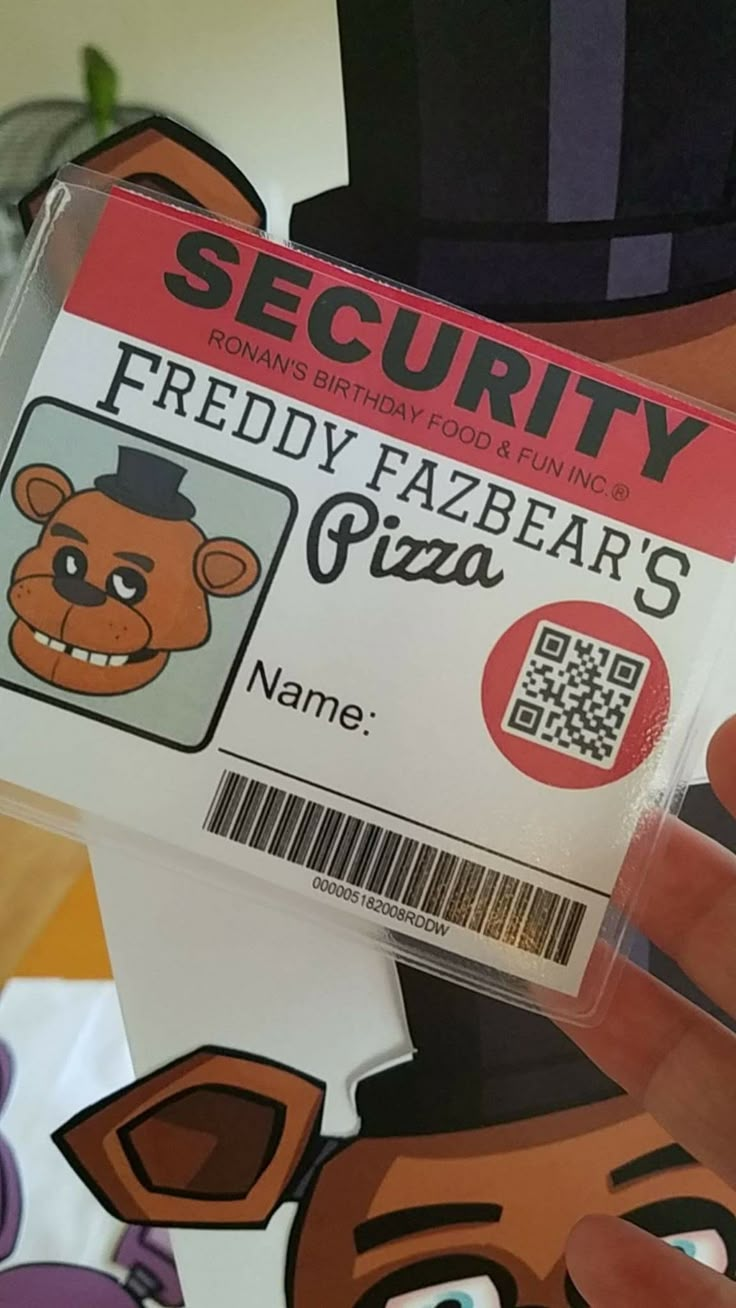 a person holding up a fake business card with a bear on it's back