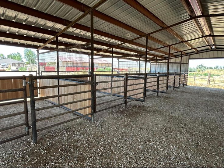 an enclosed area with several stalls for horses