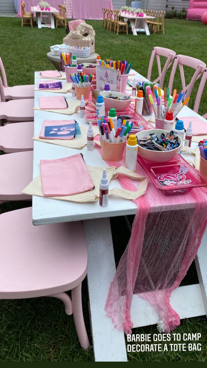 the table is set up with pink chairs and other items for children's birthday party