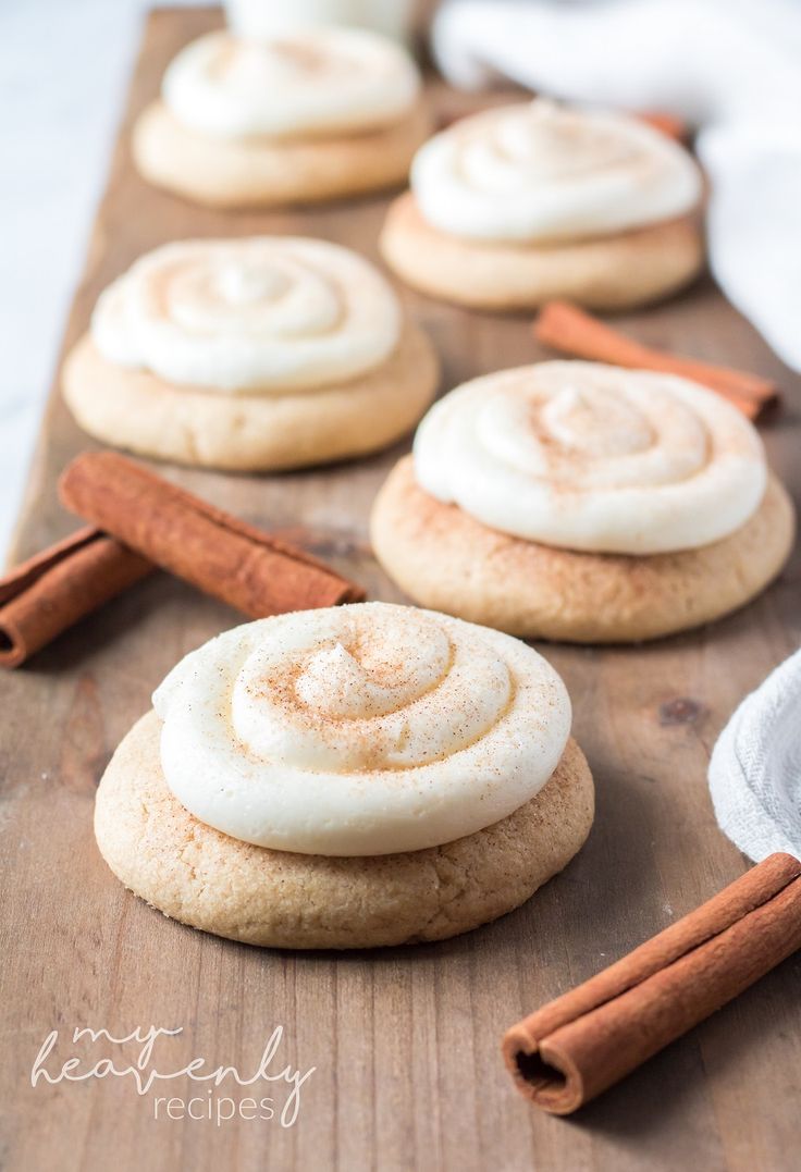 cinnamon roll cookies on a cutting board with cinnamon sticks