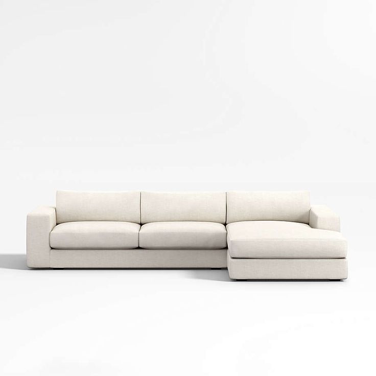 a white couch sitting on top of a white floor