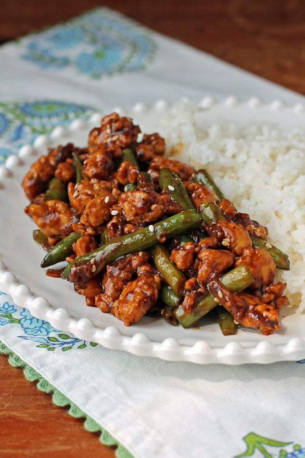 a white plate topped with rice and green beans