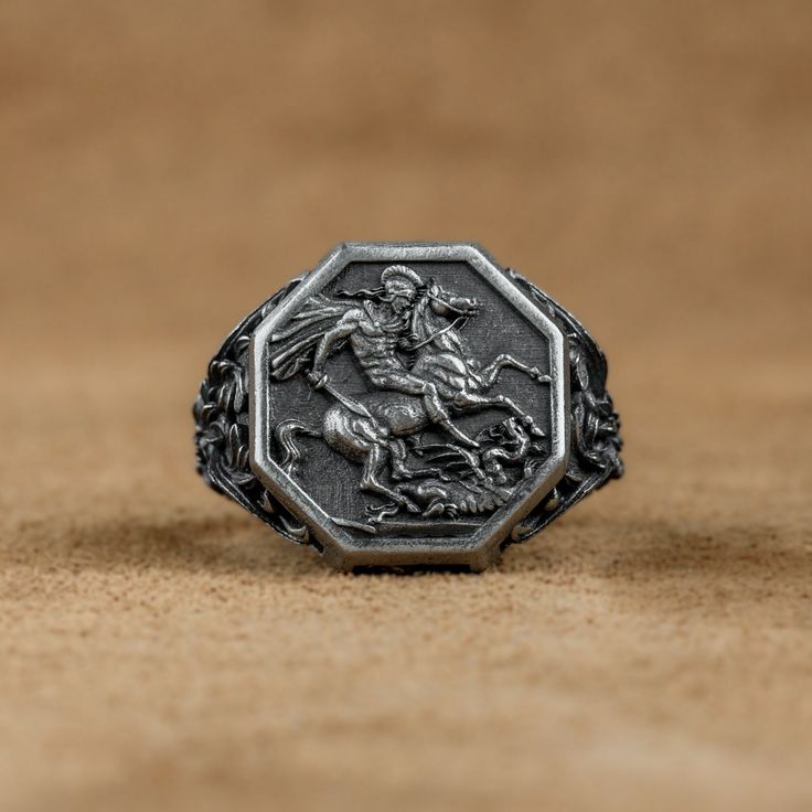 Saint George of Lydda Men Signet Ring, St George with Dragon Ring, St George Christian Ring, Religious Gift Ring For Family, Wedding Gifts   Made of 925 silver and handcrafted by hand, this ring is not only an accessory piece that complements your daily elegance, but also has details that will reflect your character and style. It is also a great gift to give to your loved ones on their special days. At SavisSilver, we always give importance to the satisfaction of our customers, we recommend you Wedding Rings Engraved Metal, Engraved Metal Wedding Rings, Men Signet Ring, Christian Ring, Dragon Ring, Saint George, Family Wedding, St George, Gift Ring