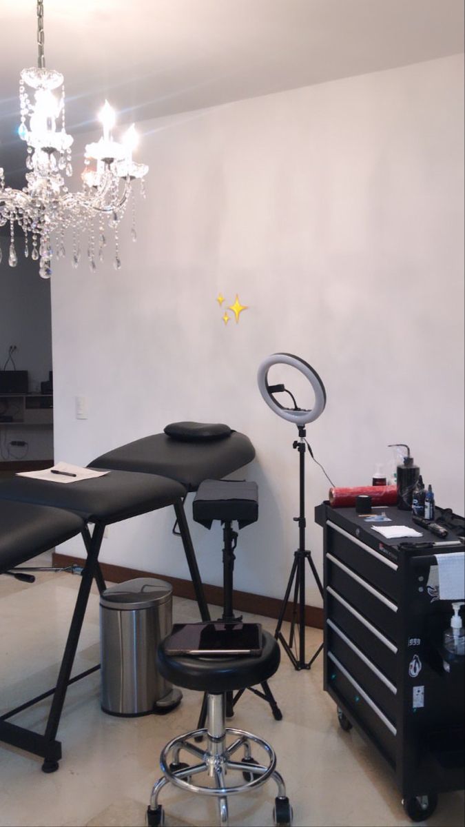 a hair salon with chairs and lights in the corner, chandelier hanging from the ceiling