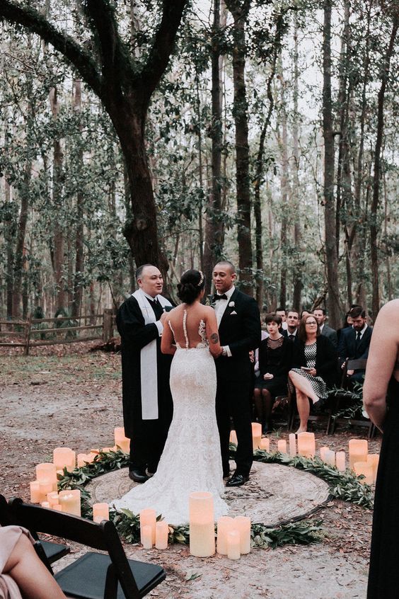 the bride and groom are getting married in the woods