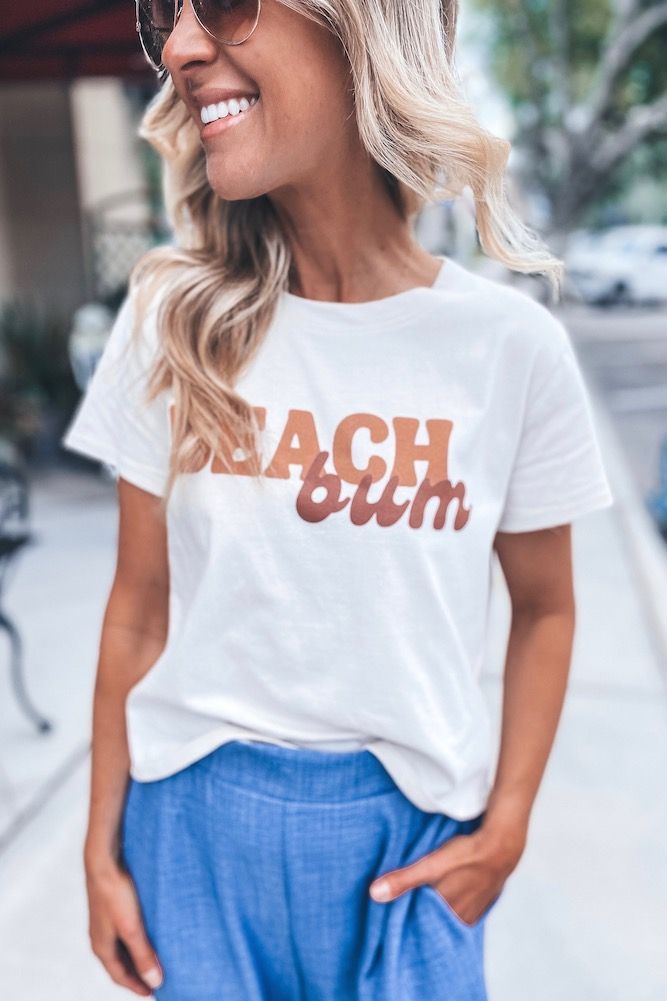 Beach Bum Tee | Sophie & Trey Trendy Tops For Weekend Wear, Casual Cotton Tops For Beach Season, Casual Screen Print T-shirt For Day Out, Cute Crew Neck T-shirt For Day Out, Sporty Cotton Tops For Day Out, Casual Letter Print Top For Day Out, Casual Tops With Letter Print For Day Out, Cute Graphic Print T-shirt For Day Out, Trendy Summer Tops For Weekend Wear