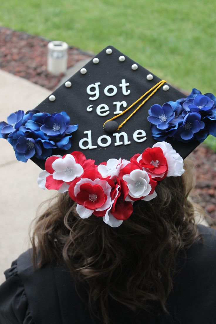 a woman wearing a graduation cap with flowers on it's head and the words got er done