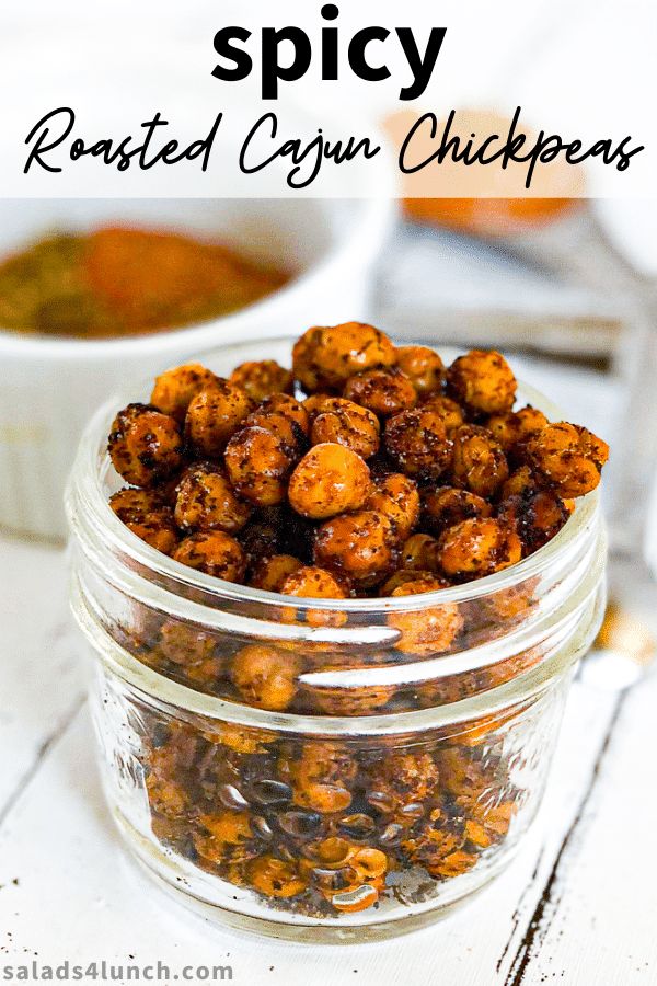 a glass jar filled with roasted cauliflower next to a bowl of chili sauce