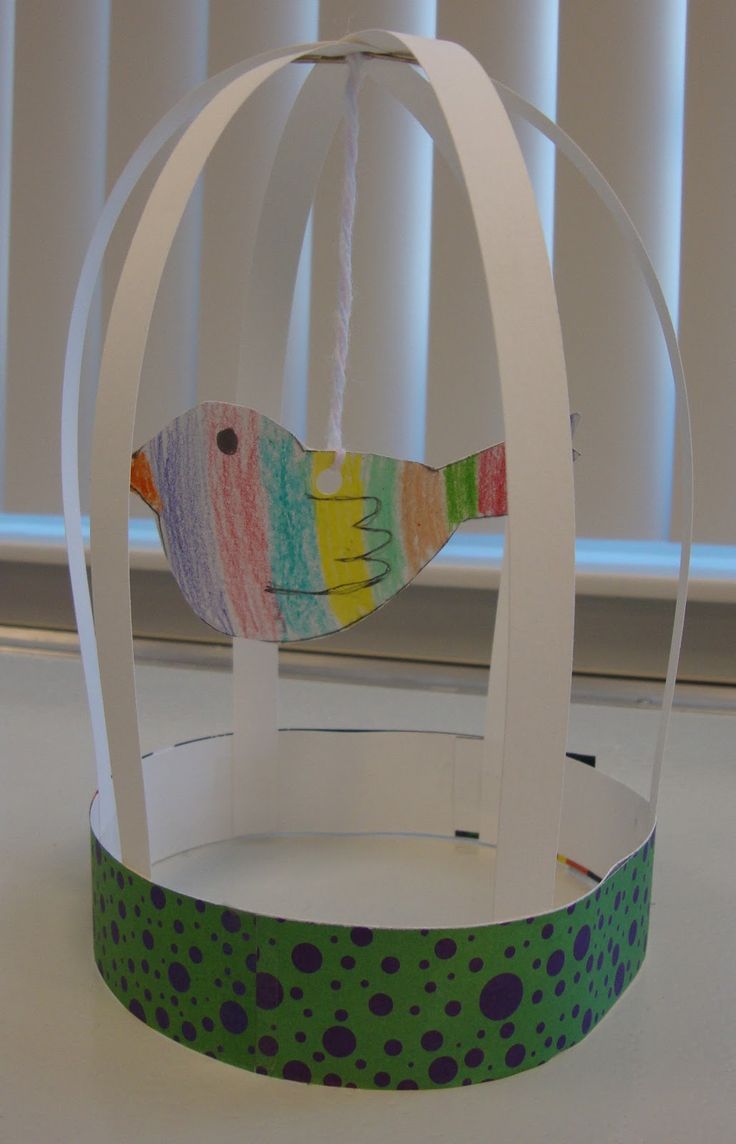 a bird in a cage made out of paper