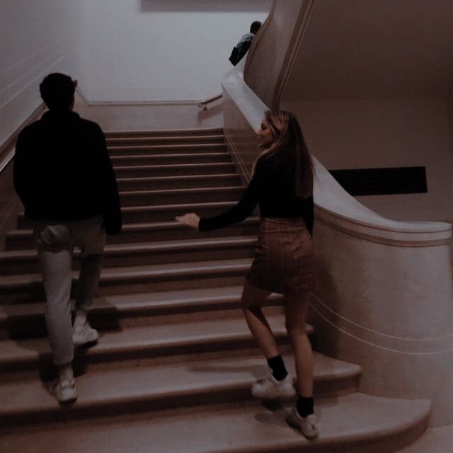 two people are walking up some stairs