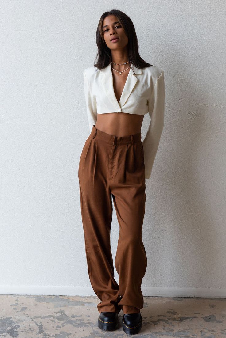 Meet your new fav pant for any season! Timeless and trendy are the Giselle Trouser featuring a loose fit with front pleat detail, side pockets and high waist. Color: Brown Loose Fit Front Pleats Pockets Wide Leg Mid Rise 100% Tencel Model is 5'7", size 25 in bottoms and is wearing size small High Waist Harem Pants For Work, Chic Relaxed Fit Tapered Leg Cargo Pants, Chic Tapered Leg Cargo Pants For Work, High Waist Harem Pants With Pockets For Day Out, Chic Harem Pants With Pockets For Day Out, Trendy Harem Pants With Loosely Fitted Hips For Work, Chic Relaxed Fit Cargo Pants, Chic High-waisted Cargo Pants For Day Out, Chic Relaxed Fit Cargo Pants For Work