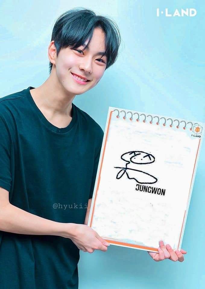 a young man is holding up a notebook with the drawing on it and smiling at the camera