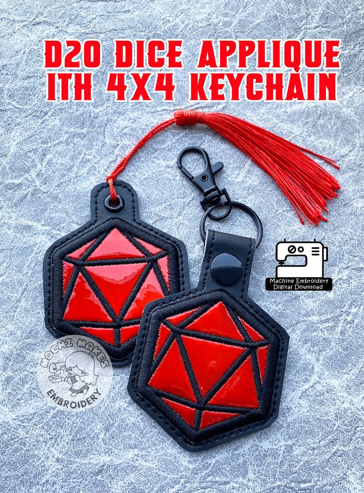 two red and black keychains with tassels attached to them on ice