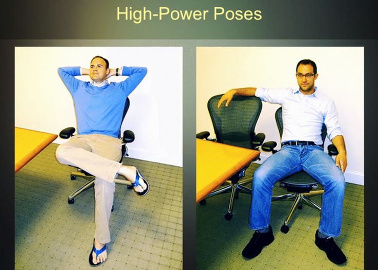 a man sitting in an office chair with his arms behind his head