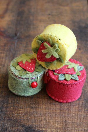 three felt covered boxes with strawberries on them