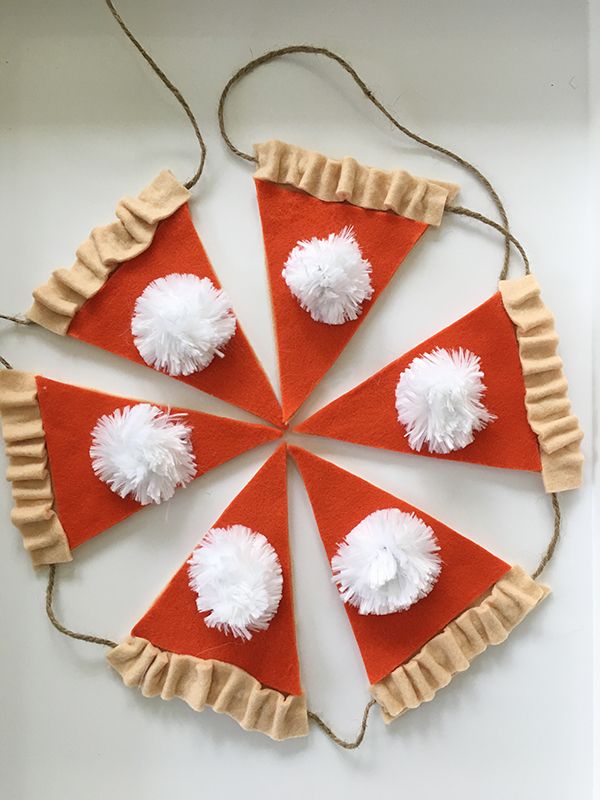 four slices of pizza with white pom - poms on them are arranged in a circle