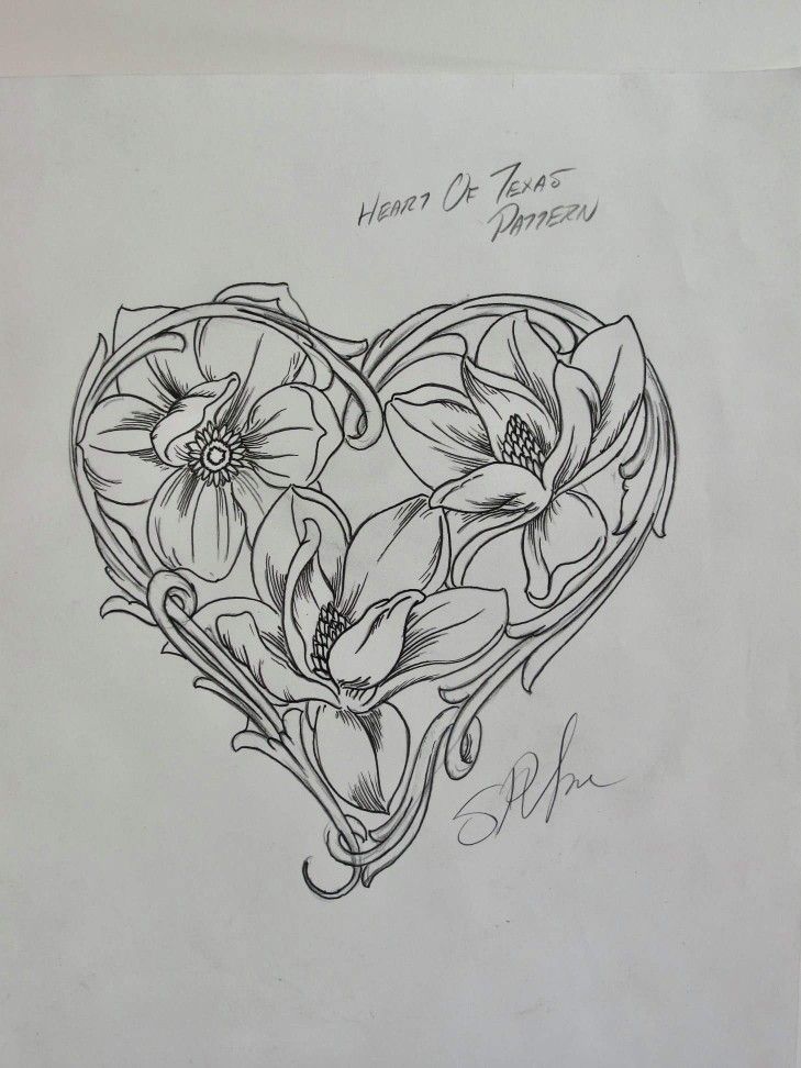 a heart shaped tattoo with flowers on it