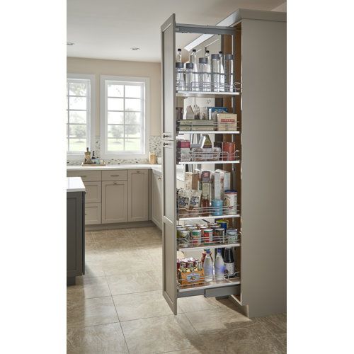 an open pantry door in a kitchen with lots of items on the shelves and drawers