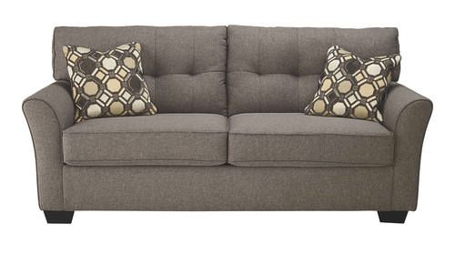 a gray couch with two pillows on it