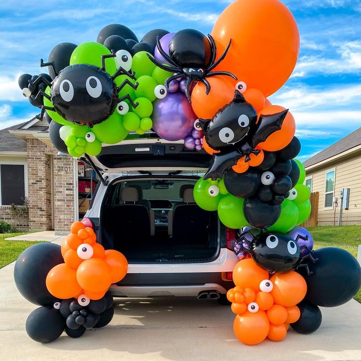 an suv decorated with balloons and decorations for halloween