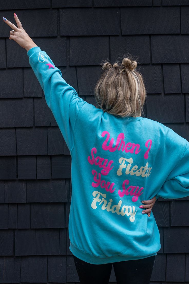 Fiesta Friday crewneck sweatshirt. This trendy sweatshirt with back print is a must for Fiesta Fridays! Pair with the Fiesta Friday kid's hoodie for the coolest matching mom & kid outfits. Shop the full Krista Horton x Slyfox collection for more trendy mom sweatshirts, matching family sweatshirts & everything you need to achieve the ultimate cool mom aesthetic. This one's great for non-mom's too! Size Reference: Krista is wearing a size XL Blue Screen Print Sweatshirt For Streetwear, Oversized Blue Sweatshirt With Screen Print, Blue Crew Neck Sweats For Spring, Blue Long Sleeve Hoodie With Text Print, Blue Graphic Print Sweats For Streetwear, Trendy Crew Sweats For Spring, Trendy Blue Graphic Print Sweatshirt, Blue Graphic Print Hoodie With Crew Neck, Trendy Blue Sweatshirt With Graphic Print