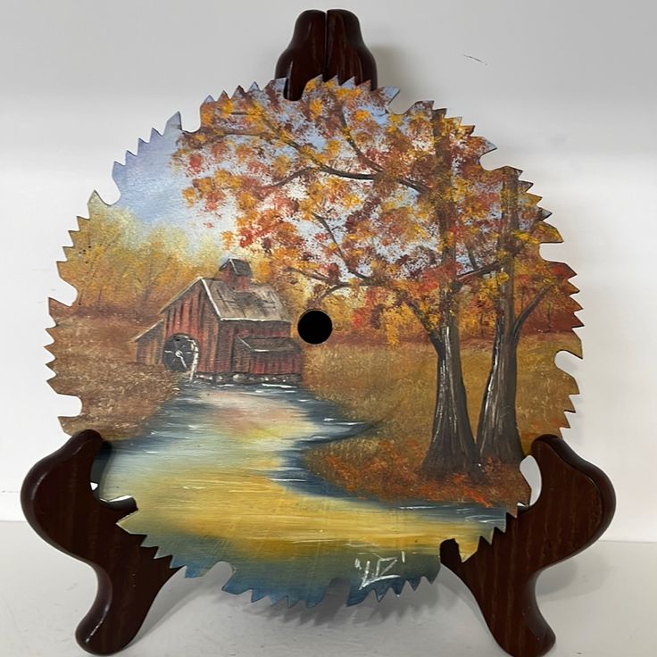 a wooden clock with an image of a farm scene on it