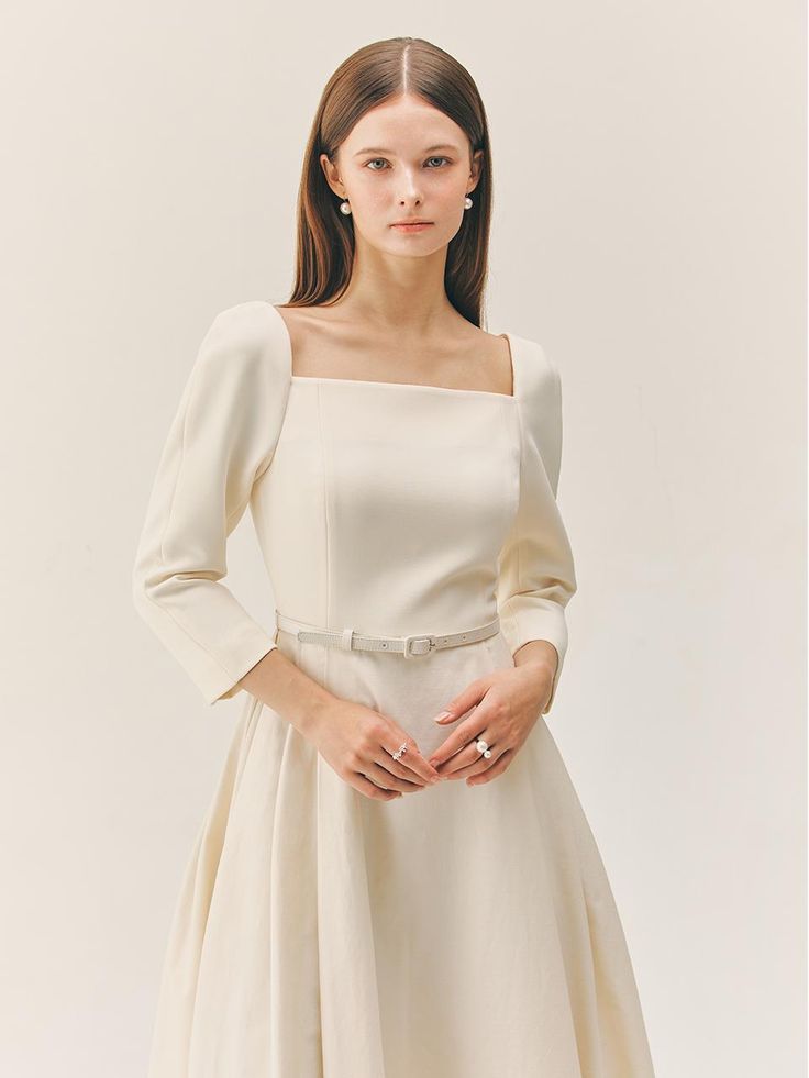 This product features an elegant long dress with a square neckline that gracefully frames the collarbone and enhances the garment's classic charm. The fitted bodice transitions seamlessly into a flared skirt, creating a silhouette that celebrates the timeless beauty of a full sweep. Designed with three-quarter sleeves, this dress marries modesty with a touch of sophistication. - This square neck dress is meticulously crafted to accentuate a poised and graceful silhouette.- The flared skirt Classic Mini Dress With Straight Neckline For Evening, Classic Evening Mini Dress With Straight Neckline, Formal Feminine Mini Dress With Straight Neckline, Classic Midi Dress With Fitted Bodice For Dinner, Formal Mini Dress With Straight Neckline, Feminine Mini Dress With Straight Neckline For Formal Occasions, Chic Square Neck Mini Dress For Dinner, Feminine Square Neck Dresses For Banquet, Square Neck Spring Evening Dress For Formal Occasions