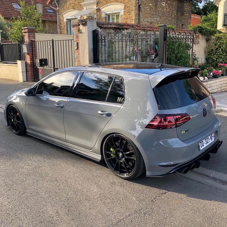 a car parked on the street in front of a house