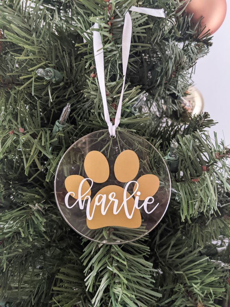 a glass ornament with an orange and white dog's paw on it