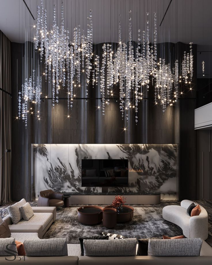 an elegant living room with chandelier hanging from the ceiling