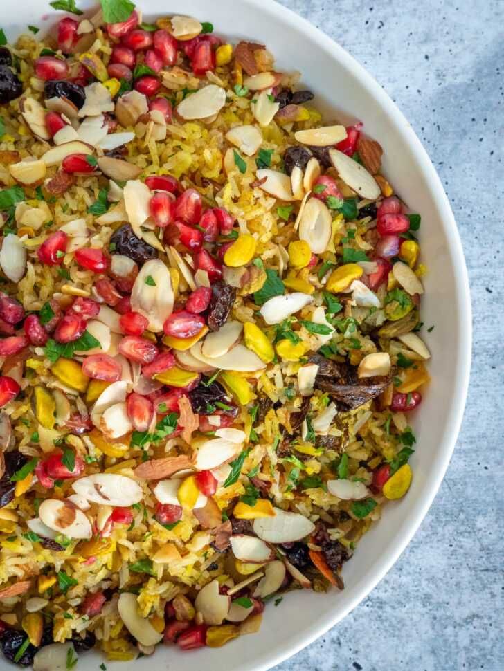 a white bowl filled with lots of different types of food on top of a table