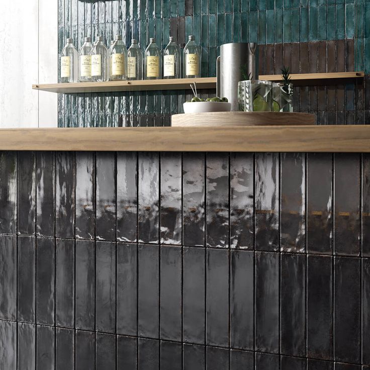 a counter top with bottles on it in a restaurant or bar, next to shelves